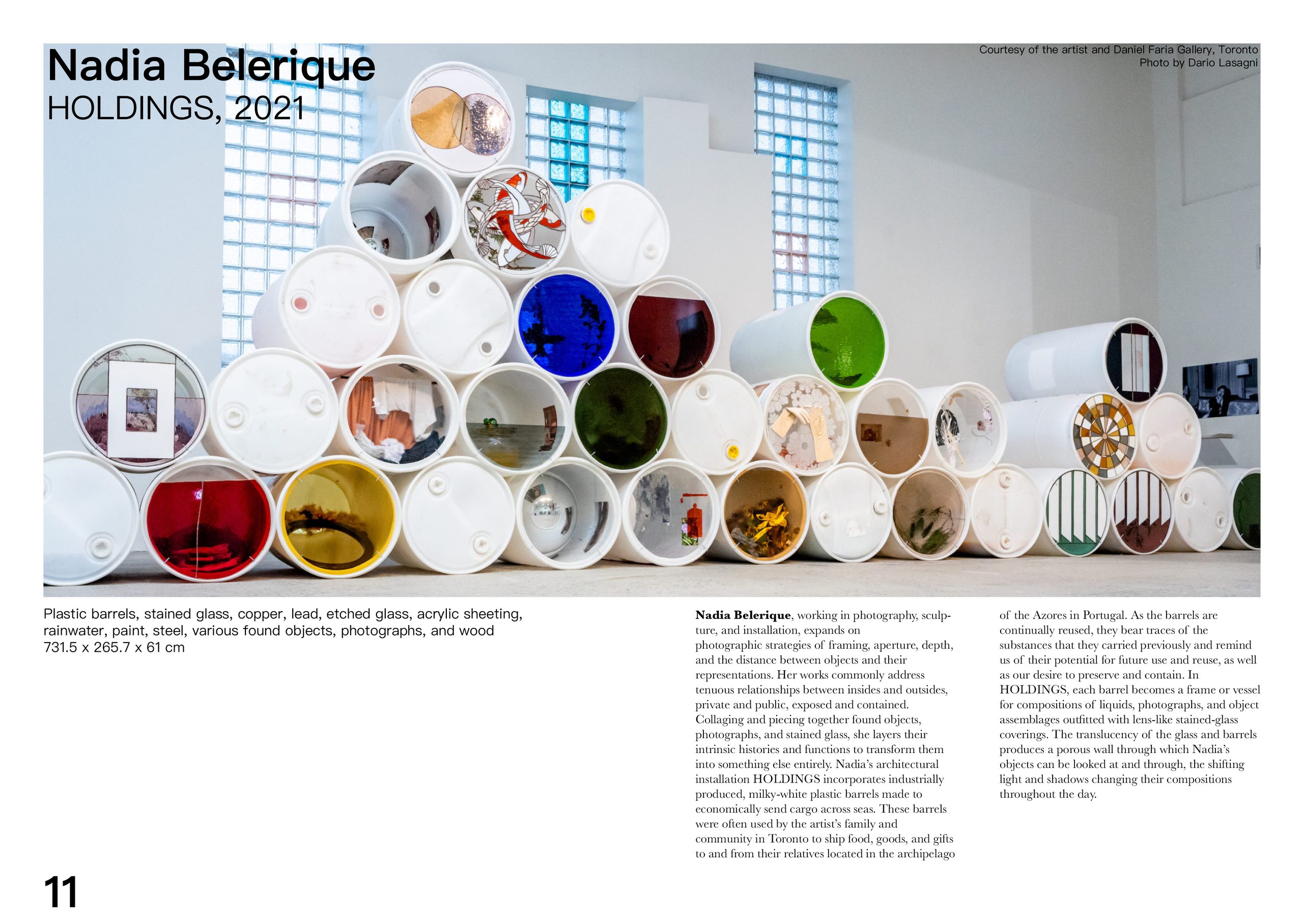 A catalogue spread for Nadia Belerique’s “HOLDINGS, 2021”, showing a photograph of stacked open-ended plastic barrels filled with found objects, with the caption and essay text set in columns alongside.