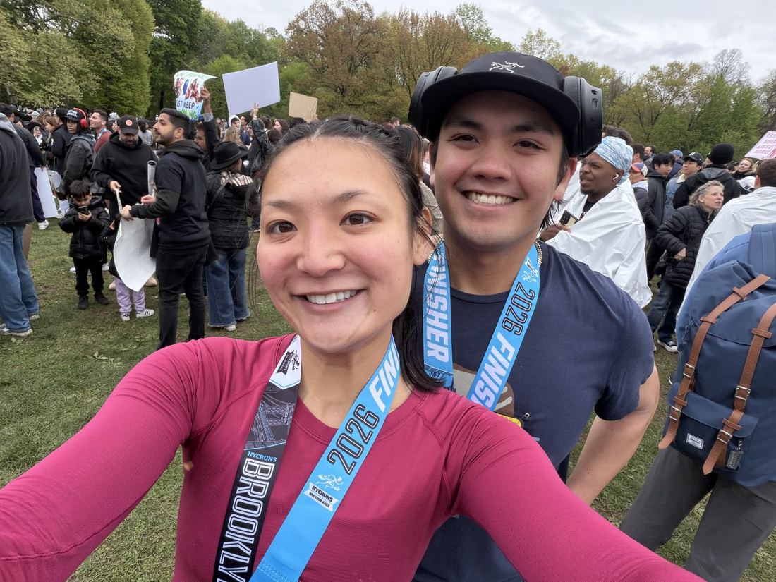 Gabe and Hannah smiling with their medals after the Brooklyn Half Marathon.